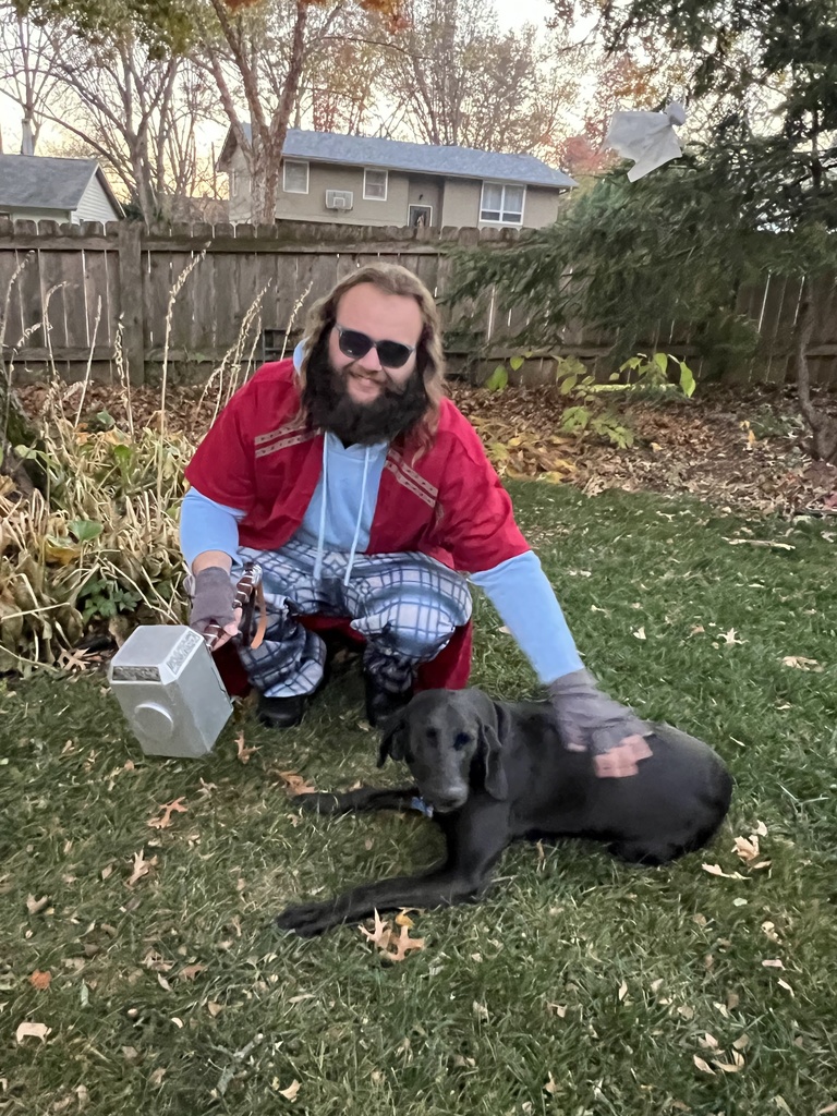 Christian dressed as Thor sitting beside Tom's dog, Molly