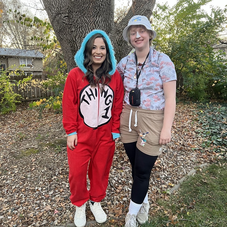 Natalie, in a Thing 1 onesie, and Holly, dressed as a Tacky Tourist